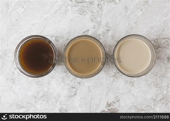four coffee cups row marble backdrop displaying different mixtures milk coffee