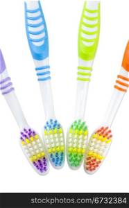 four colorful toothbrushes isolated on white background
