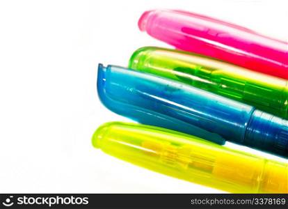 Four coloured pens on white background