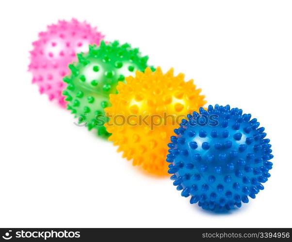 four coloured pimpled balls over white background