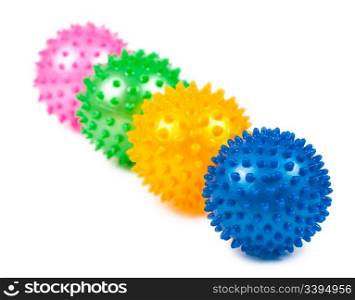 four coloured pimpled balls over white background