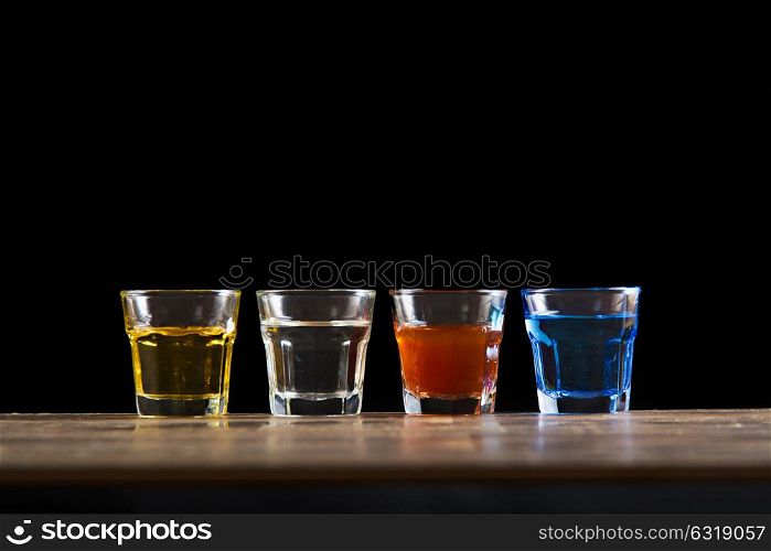 four diferent color mini glass shot alcoholic drink
