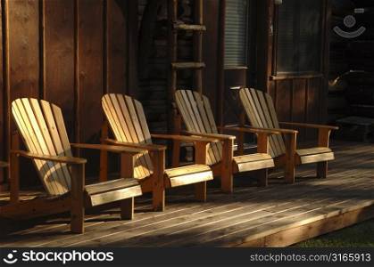 Four empty chairs on a deck