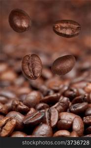 four falling beans and roasted coffee beans background with focus foreground
