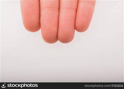 Four fingers of a child hand partly seen in view