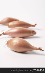 Four Fresh Echalion Shallots On White Background