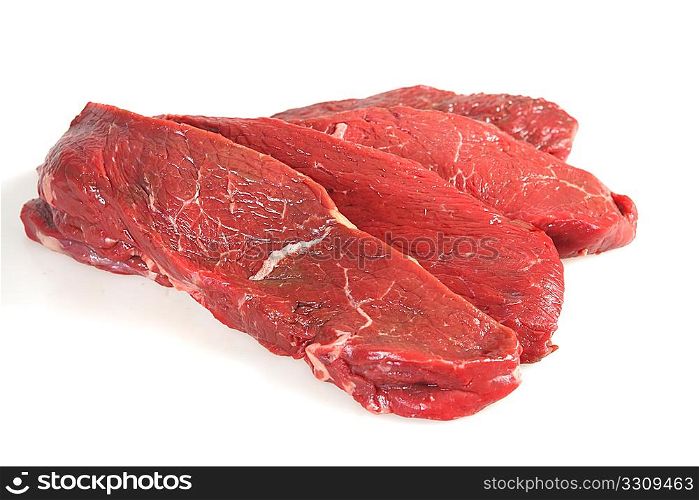 Four fresh, raw rump steaks, with shadow, on a white background.