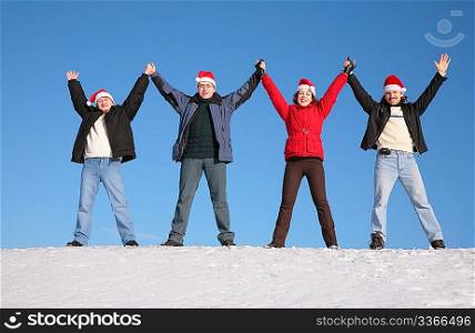 four friends greetings on snow in santa claus hats