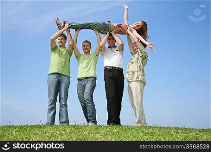 Four friends have lifted the girl upwards