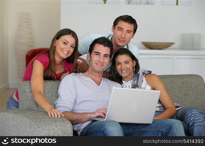 Four friends looking at photos on the computer