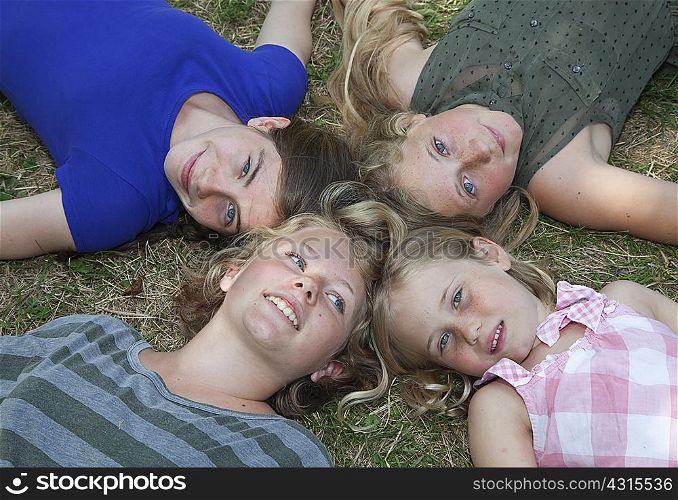 Four girls lying on grass