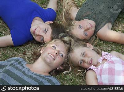 Four girls lying on grass