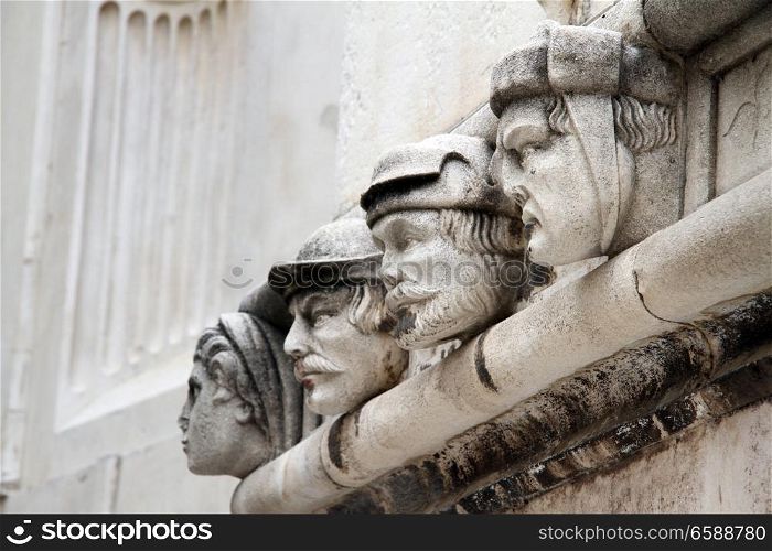 Four heads on the wall of cathedral in Shibenik, Croatia