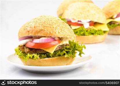 four homemade hamburgers isolated on white background
