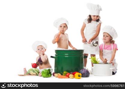 Four kids play with vegetables and kitchenware, cooking the soup