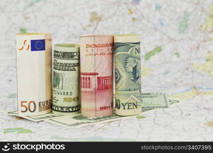Four, major currencies are placed on a single map, symbolizing their connected financial nature in a global marketplace
