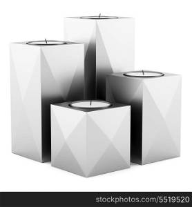 four metallic candlesticks with candles isolated on white background