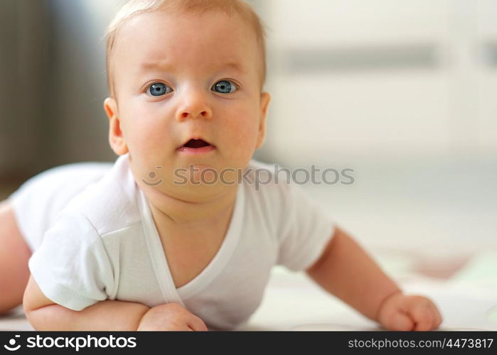 Four months old baby crawling on floor