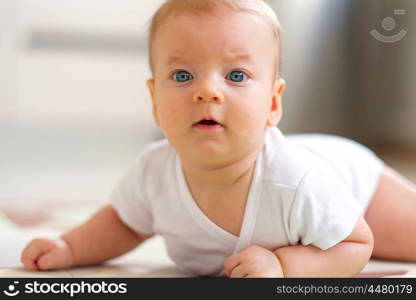 Four months old baby crawling on floor