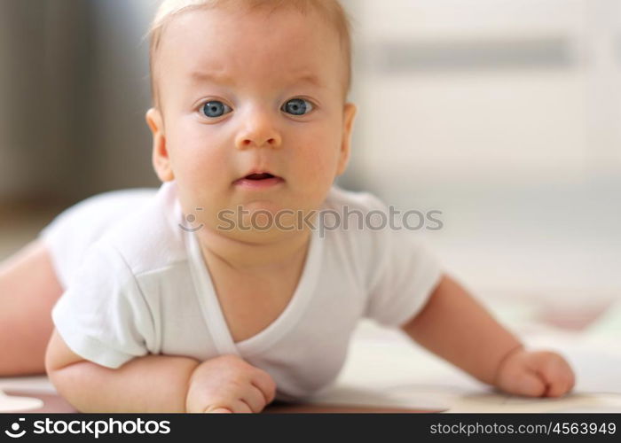 Four months old baby crawling on floor