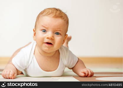 Four months old baby crawling on floor