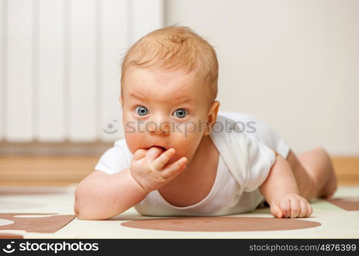 Four months old baby crawling on floor