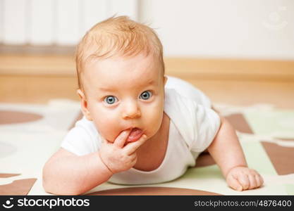 Four months old baby crawling on floor