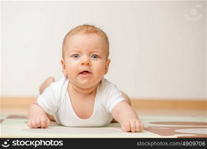 Four months old baby crawling on floor