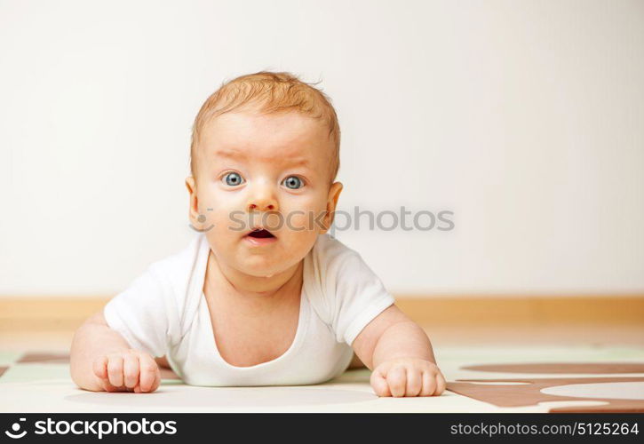 Four months old baby crawling on floor