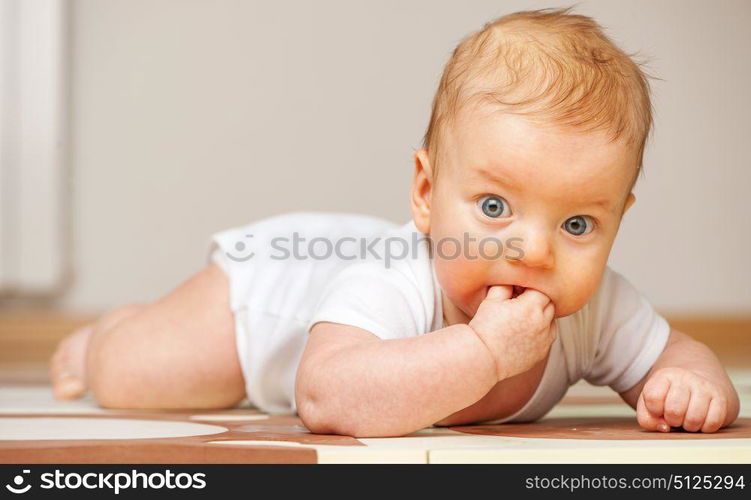 Four months old baby crawling on floor