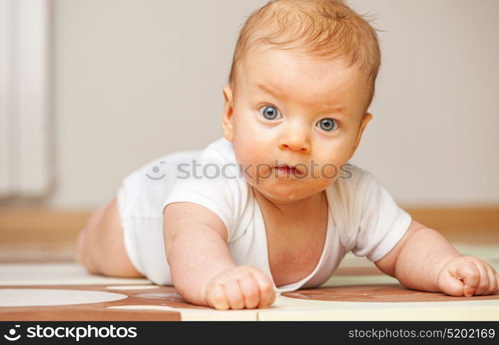 Four months old baby crawling on floor