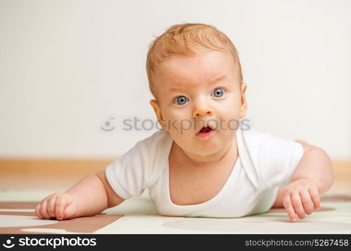 Four months old baby crawling on floor