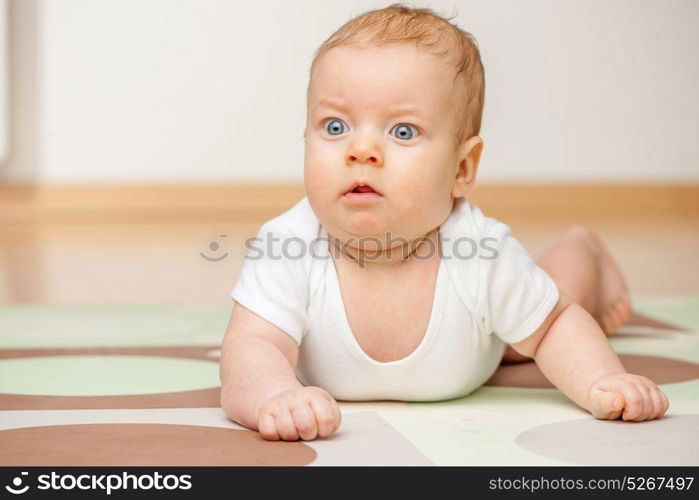 Four months old baby crawling on floor