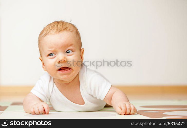 Four months old baby crawling on floor