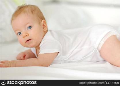 Four months old baby in bed