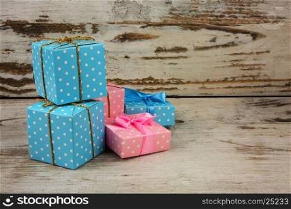 Four packets, christmas gifts on old wooden table Christmas decoration with copy space on the right side.Horizontal view.