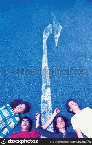 Four people lying on road
