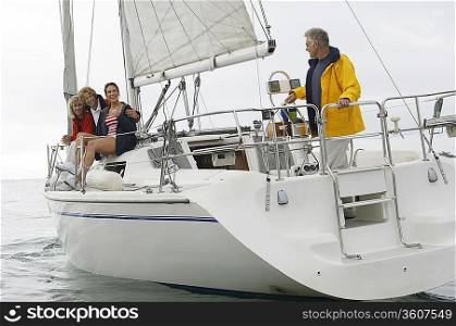 Four people on sailboat in sea