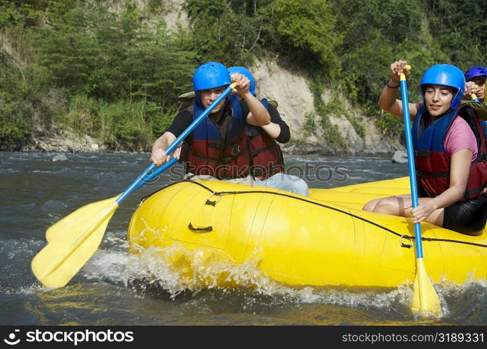 Four people rafting in a river