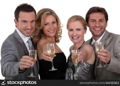 Four people toasting success