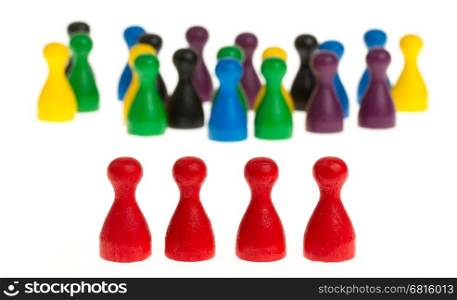 Four red pawns in front of a large group of different colored pawns
