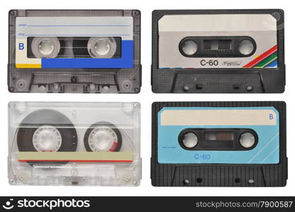Four retro cassette tapes isolated on white