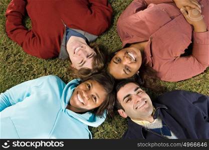 Four students lying down outdoors