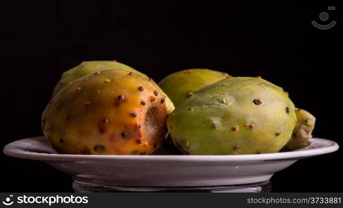 Four tasty prickly pear cactus fruits served on a plate