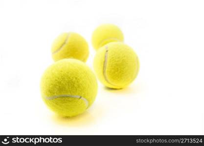 Four tennis balls isolated on white background