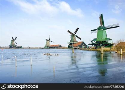 Four typically Dutch windmills in De Zaanse Schans near de river Zaan in the Netherlands