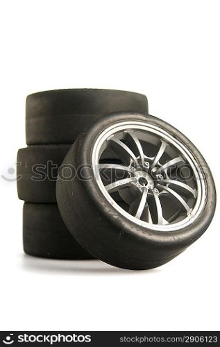 Four used race tires on white background