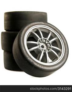 Four used race tires on white background