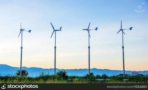 Four wind turbine in the sunset.