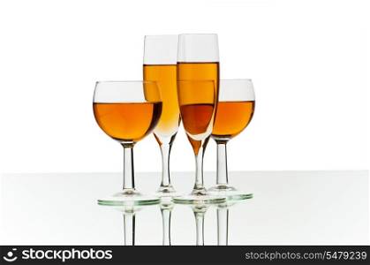 Four wine glasses on the reflective background
